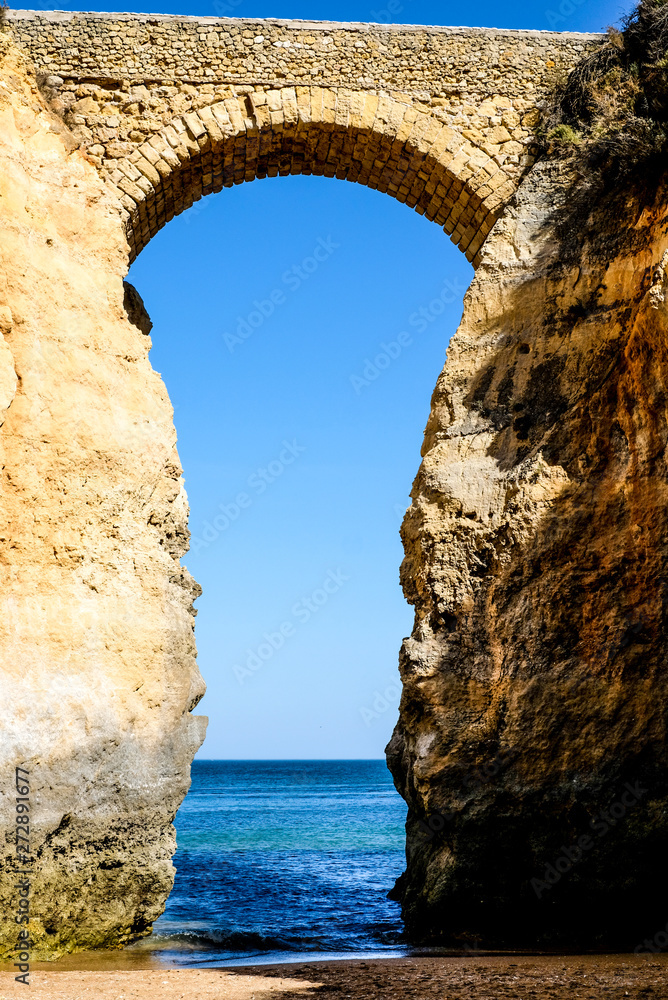 big arch on the beach in Lagos Portugal, passageway into the water