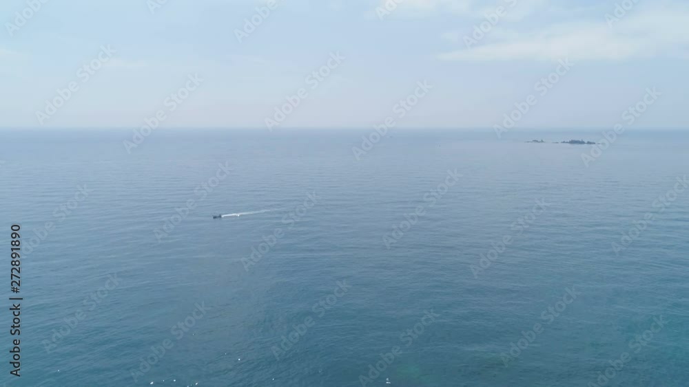 Costa Brava summer aerial view. Flying back over scenic beautiful rocky coastline seascape bay with transparent blue turquoise Mediterranean sea and yachts. Cala El Golfet, Palafrugell, Girona, Spain Costa Brava summer aerial view. Flying back over scenic beautiful rocky coastline seascape bay with transparent blue turquoise Mediterranean sea and yachts. Cala El Golfet, Palafrugell, Girona, Spain