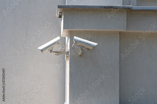 CCTV camera attached on the wall of the building, monitoring and tracking, monitoring the situation