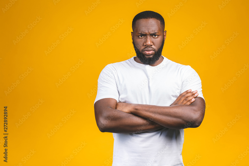 Portrait of handsome serious young african american man iisolated yellow background. Portrait of handsome serious young african american man iisolated yellow background.