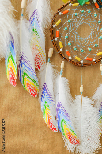 Closeup colorful dreamcatcher details on striped craft wrapping paper background