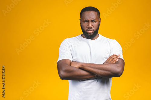 Portrait of handsome serious young african american man iisolated yellow background.