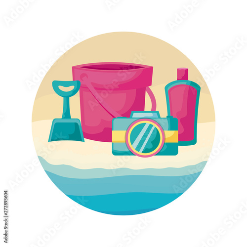 bucket with camera and bottle of blocker in beach