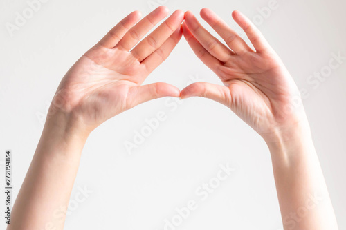 Wallpaper Mural Hands show the palms and splice fingertips together to be triangle frame. Torontodigital.ca