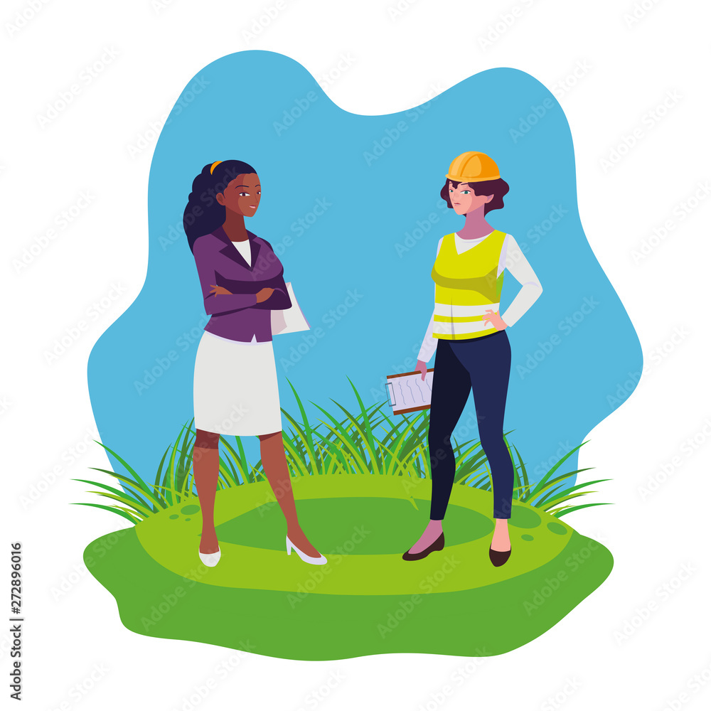 female builder and afro engineer woman on the lawn