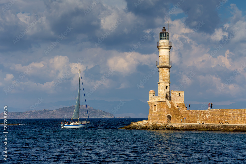 View of the town lighthouse, yacht and the sea View of the town lighthouse, yacht and the sea