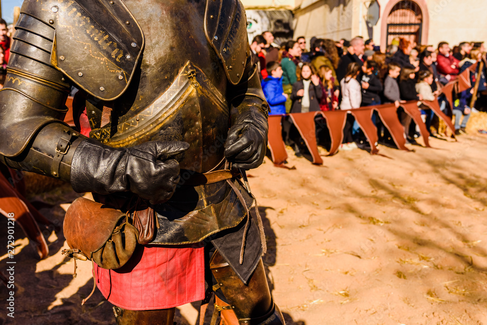 Valencia, Spain - January 27, 2019: An actors dressed as medieval knights in armor riding horses during an exhibition at a children's festival.