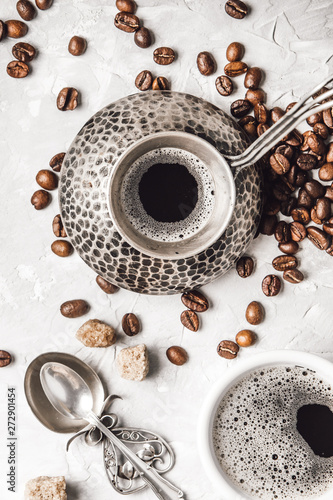 Coffee with coffee beans on grey textured background. Top view with copy space. Background with free text space. © zadorozhna