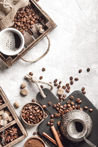 Coffee with coffee beans on grey textured background. Top view with copy space. Background with free text space.