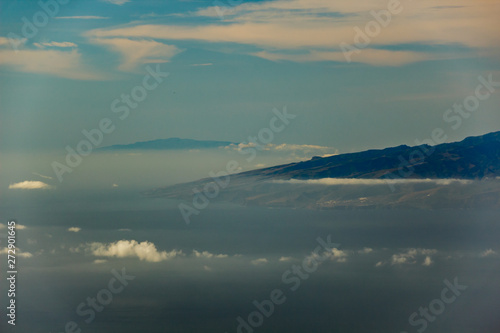 La Gomera and El Hierro islands  flying in the air between different clouds. Bright blue sky. View from 1900m of altitude. Teide National Park  Tenerife  Canary Islands.