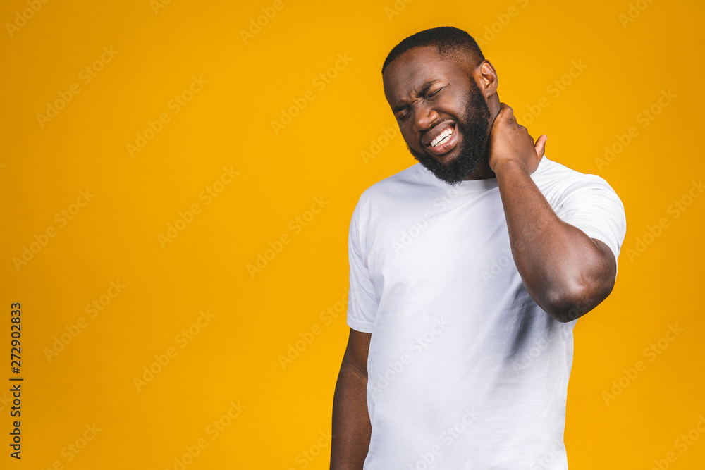 Unhappy young handsome african american man with really bad neck pain, after long hours of work, studying, isolated white background. Negative human emotions, facial expressions. Unhappy young handsome african american man with really bad neck pain, after long hours of work, studying, isolated white background. Negative human emotions, facial expressions.
