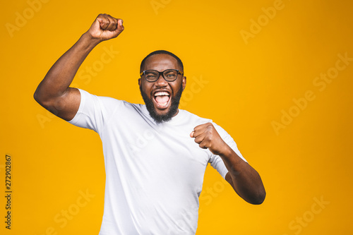 Portrait of excited young African American male screaming in shock and amazement. Surprised man looking impressed, can't believe his own luck and success photo