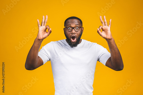 Afro american man over isolated background smiling positive doing ok sign with hand and fingers. Successful expression.