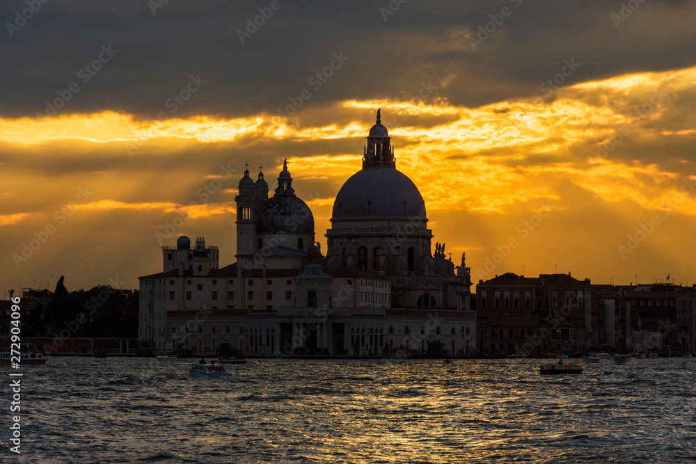 Beautiful Salute Basilica (Saint Mary of Helath) old domes at sunset in Venice