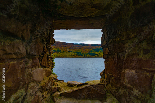 Stone cave frame with lake and part of mountain view in the frame