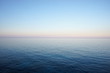Seascape in delicate pastel colors with the horizon of the sea and clear sky early in the morning. Mediterranean Sea