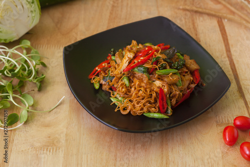 Vegetarian thai food,stir-fried rice noodles spicy ,on wooden background