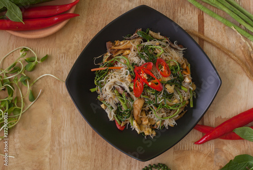 Vegetarian thai food,stir-fried rice white noodles spicy top view on wooden background