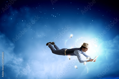 Smiling joyful levitating young man. Mixed media © Sergey Nivens