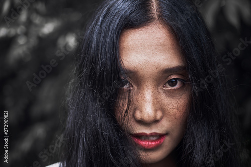 Close-up photos of a woman face with freckles The eyes look uncompromising.