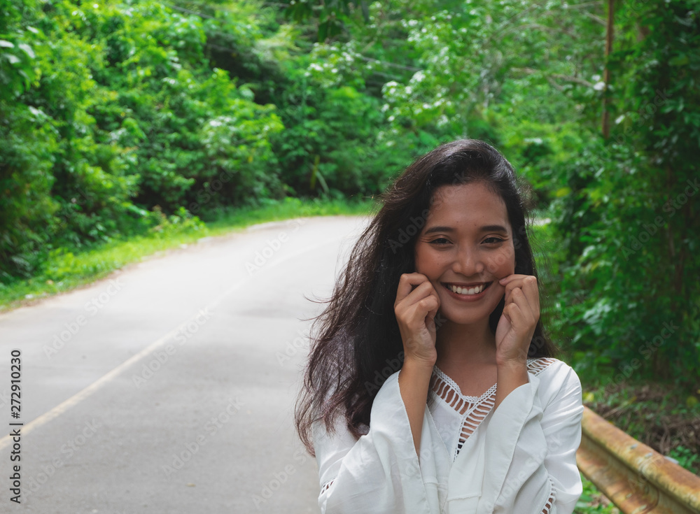 Young beautiful woman walking on the way in the jungle Young beautiful woman walking on the way in the jungle