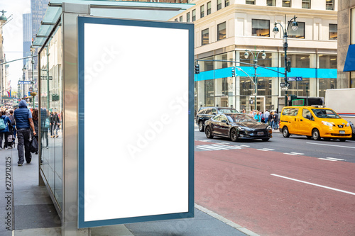 Blank billboard at bus stop for advertising, New York city buildings and street background © Rawf8