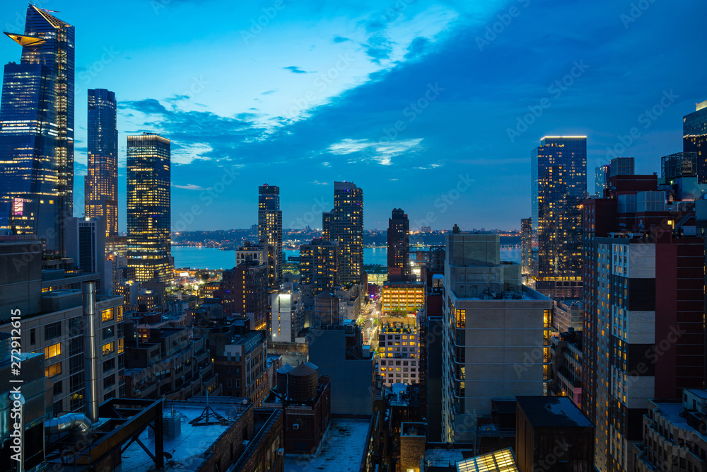 Obraz premium Aerial view of Manhattan skyscrapers lights, New York city, blue sky in the evening