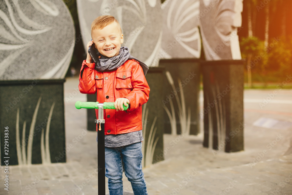 Cute little boy in a park. Child playing with a skate. Cute little boy in a park. Child playing with a skate.