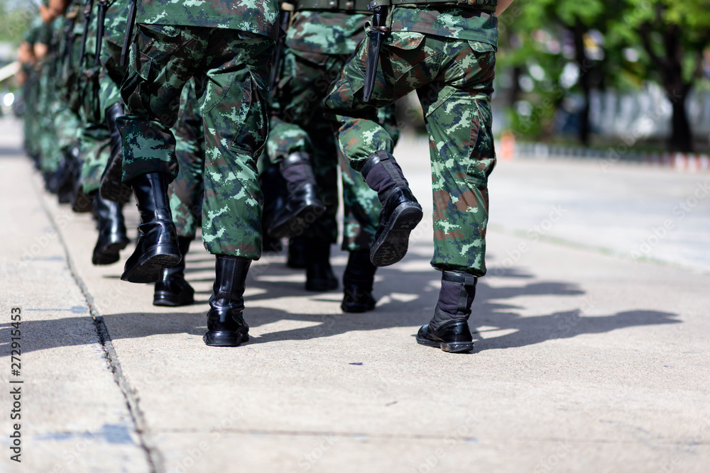 iron discipline of the best soldiers in army, a column of soldiers in uniform and with modern automatic weapons in hands of boots marching. iron discipline of the best soldiers in army, a column of soldiers in uniform and with modern automatic weapons in hands of boots marching.