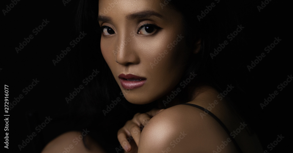 beautiful young woman closeup face and glossy skin under glamour low key concept beautiful young woman closeup face and glossy skin under glamour low key concept