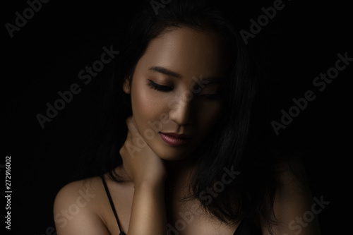 Fotografie beautiful young woman closeup face and glossy skin under glamour low key concept