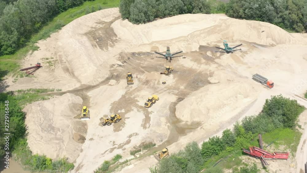 Industrial equipment at mining area. Sky view of mining equipment at sand mine. Mining conveyor working at sandpit. Aerial view of mining machinery at sand quarry Industrial equipment at mining area. Sky view of mining equipment at sand mine. Mining conveyor working at sandpit. Aerial view of mining machinery at sand quarry