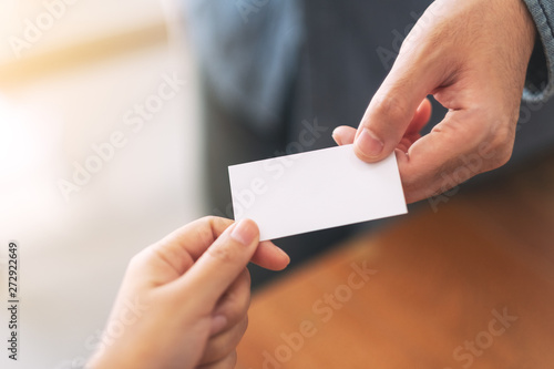Two businessman holding and exchanging empty business card