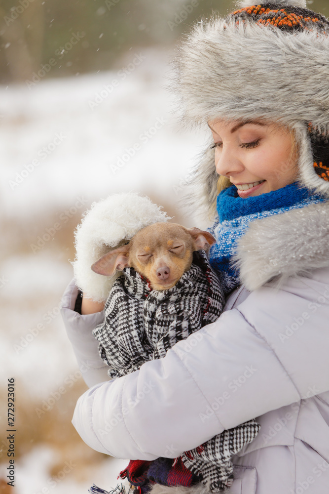 Woman hug warming her little dog in winter Woman hug warming her little dog in winter
