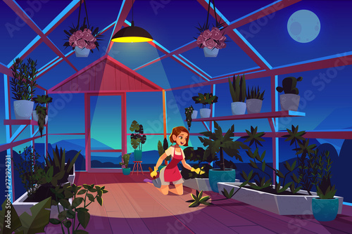 Woman in greenhouse at night time care of garden plants. Girl with shovel in orangery interior with glowing lamp, glass windows and wooden floor, place for growing flowers. Cartoon vector illustration
