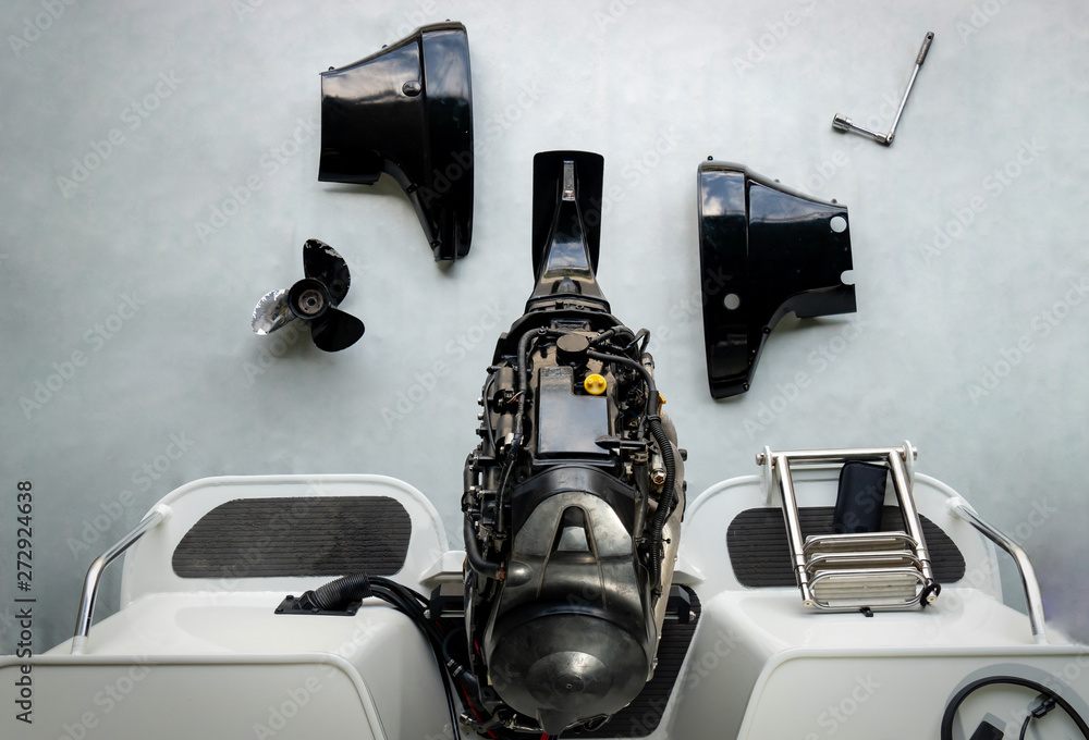 Fototapeta premium Repairing engines on aluminum boats , The technician is removing the boat parts to make the paint