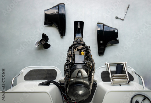 Repairing engines on aluminum boats , The technician is removing the boat parts to make the paint