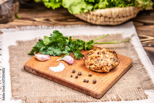 Burger cutlet with spices on a board