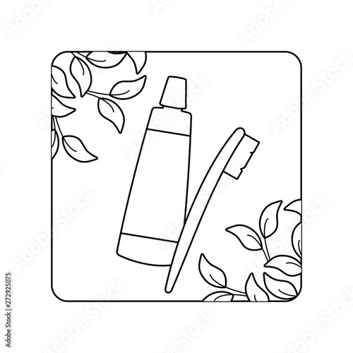 cream tube and toothbrush with leafs in frame