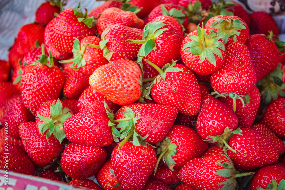 Ripe strawberries pile at street market. Ripe strawberries pile at street market.