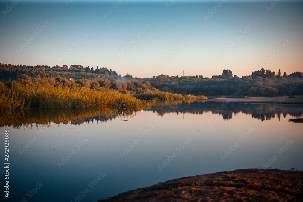 beautiful sunset on the river bank in the summer evening beautiful sunset on the river bank in the summer evening