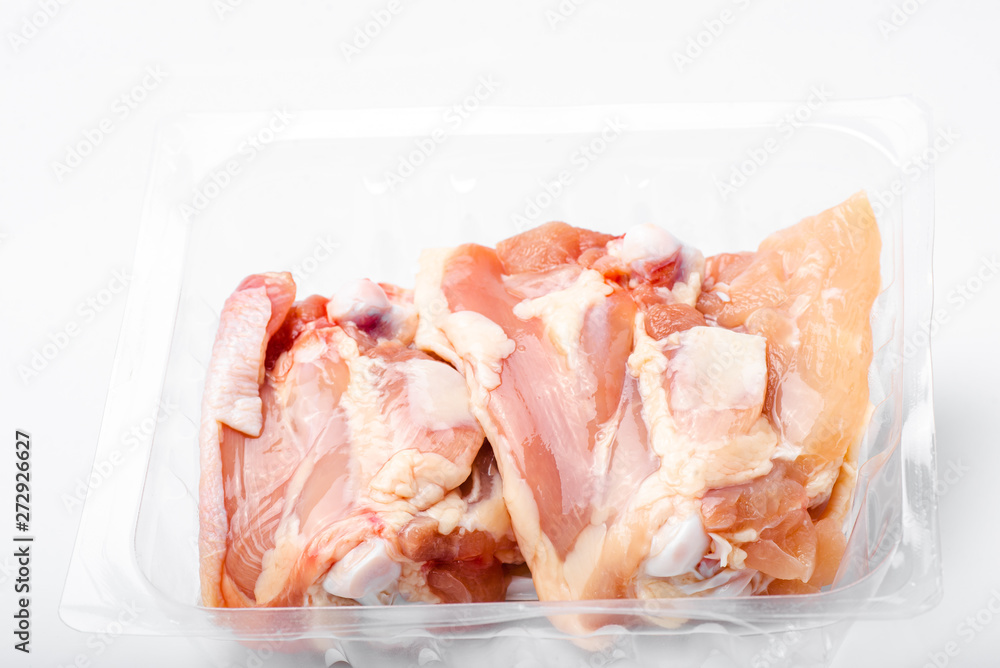 Chicken thighs in plastic pack from supermarket, ready to cook.