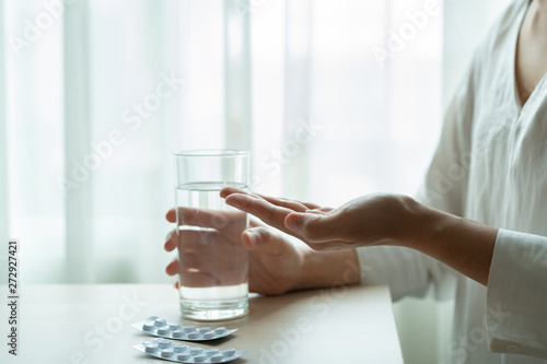 depressed women hand hold medicine with a glass of water, healthcare and medicine recovery concept