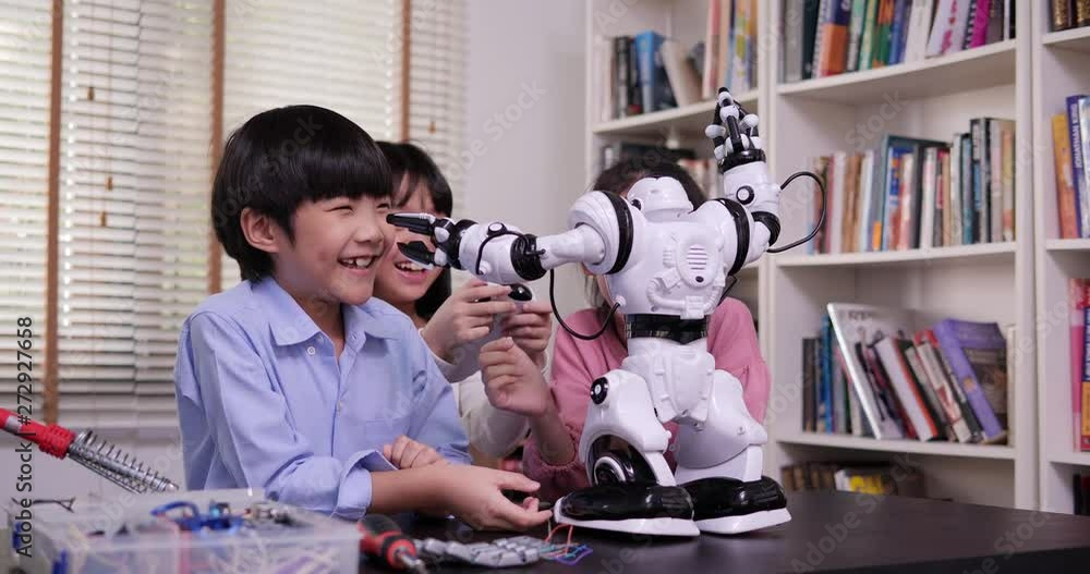 Group of student work on a programable robot at school science class project. Technology and Education concept. Group of student work on a programable robot at school science class project. Technology and Education concept.