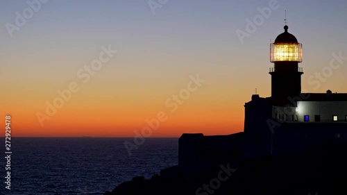 Cape St. Vincent, Portugal. Lighthouse shining brightly after sunset showing ships the safe way to sail. St. Vincent is the southwesternmost point of mainland Europe. 4K photo