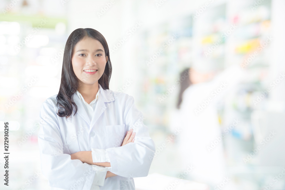 Beautiful asian female pharmacist smiling in drugstore Beautiful asian female pharmacist smiling in drugstore