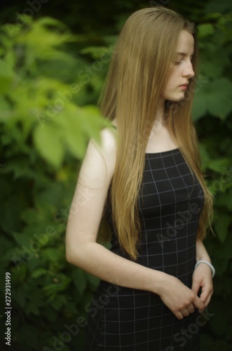 beautiful young blonde with long flowing hair on a blurry background