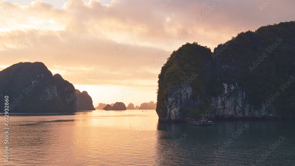 Halong bay at golden sunrise in Vietnam, South Asia. Panoramic view. Travel destination and natural background