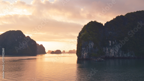 Halong bay at golden sunrise in Vietnam, South Asia. Panoramic view. Travel destination and natural background