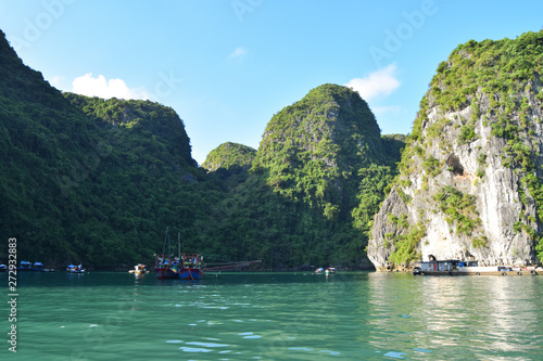 Floating village and rock islands in Halong Bay, Vietnam, Southeast Asia. Travel destination and natural background.